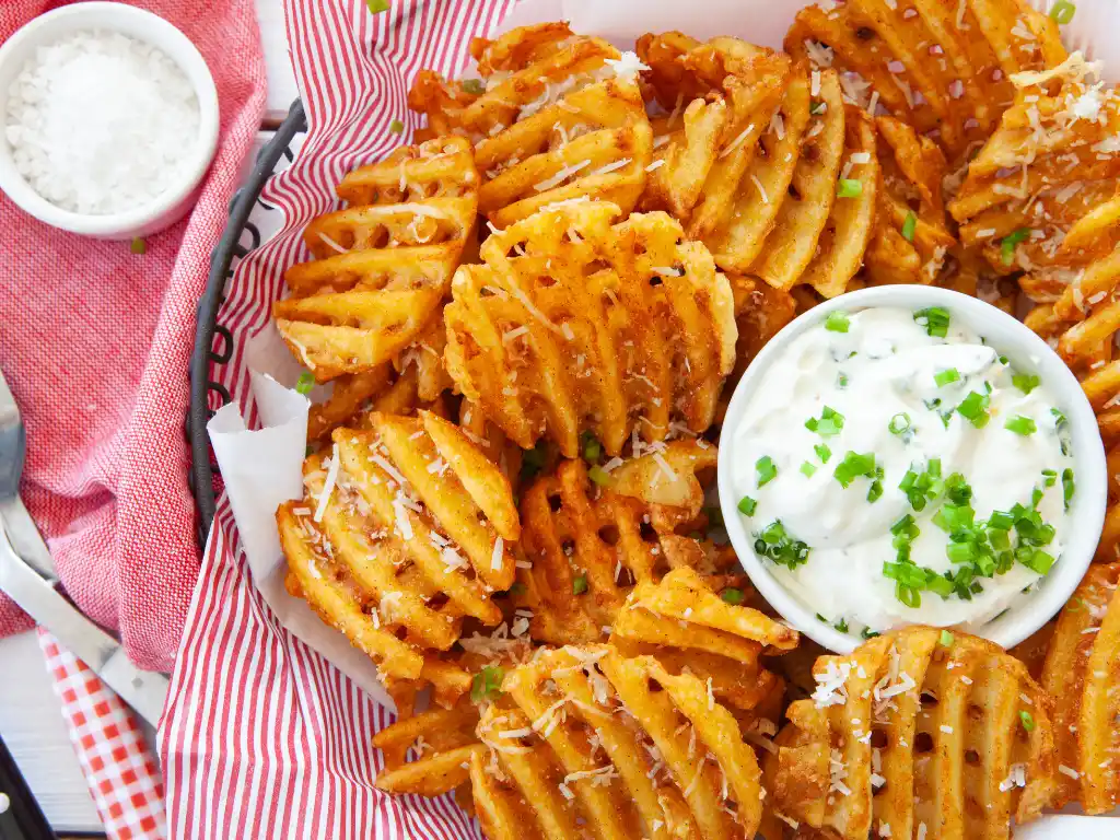 Freshly cooked Chick Fil A waffle fries recipe served with a side of dipping sauce